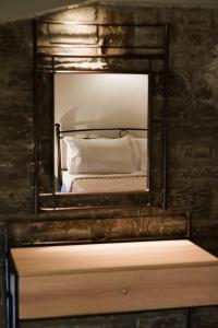 a mirror on top of a dresser in a bedroom at LOTOS Families Apartments 4 in Konitsa
