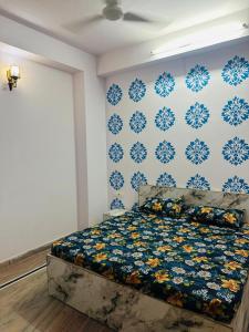 a bedroom with a bed with a blue and white wall at Royal Guest House in Jaipur +8 photos