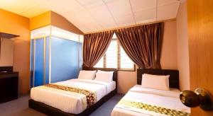 Postel nebo postele na pokoji v ubytování RAINFOREST Budget Stay