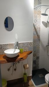 a bathroom with a white sink and a shower at Villa Beso Casa Rural in Otívar +65 photos