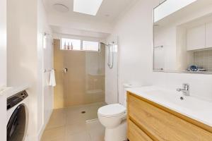 a bathroom with a toilet and a sink and a shower at The Little Tropicana in Byron Bay +41 photos