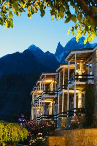a large building with mountains in the background at Eagle's Nest Hotel in Karimabad Hunza
