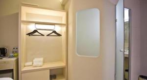 a bathroom with a mirror and a towel on a shelf at M Plus Boutique Hotel in Gelang Patah +57 photos