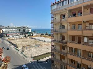 a view of a building and a street next to the ocean at Meraviglia B&B - Salerno Centro Close to the Station and Pier in Salerno
