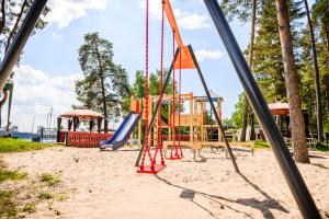 a playground with a slide and a swing at Porto Marine in Jūrmala