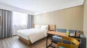 Postel nebo postele na pokoji v ubytování Borrman Hotel Xiamen Xiang'an Maxiang