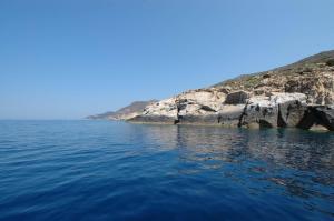 a large body of water with a rocky shore at Hotel Castello Monticello in Giglio Porto