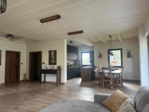 a living room and kitchen with a table and chairs at Vila Ivana in Dobroselica