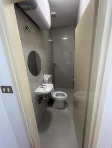 a small bathroom with a toilet and a sink at San Valentino hostel in Bašanija
