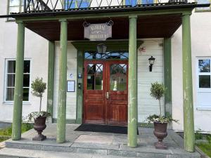 a entrance to a building with a wooden door at Grangärde Hotell in Grangärde
