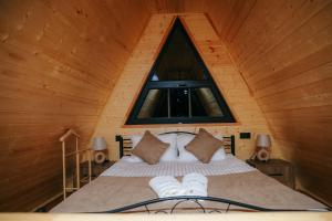 a bedroom with a large bed with a window at Drakhtiq Resort in Goris