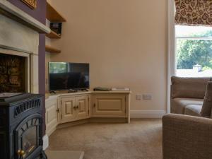 a living room with a flat screen tv on a cabinet at 4 Harney Peak in Portinscale