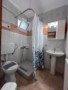 a bathroom with a shower and a toilet and a sink at ATHINA MARE-SOLE in Kallithea Halkidikis