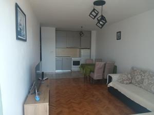 a living room with a couch and a table and a kitchen at apartman Darija Savina in Herceg-Novi +6 photos
