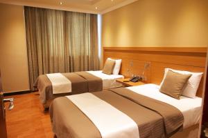 Ένα ή περισσότερα κρεβάτια σε δωμάτιο στο Nigist Towers Hotel and Apartments