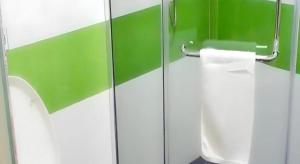a green and white bathroom with a toilet paper dispenser at 7 Days Inn Siping Xinhua Street in Siping