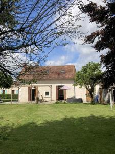 a house in a yard with a grass field at Maison du bonheur spa in Neuvic +16 photos