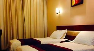 Postel nebo postele na pokoji v ubytování Super 8 Hotel Shanghai Songjiang University Town Branch