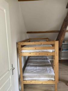 two bunk beds in a room with a attic at Maison du bonheur SPA in Neuvic