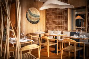 a restaurant with tables and chairs in a room at Atlantic Hôtel & Spa in Les Sables-d'Olonne