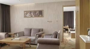a living room with a couch and chairs and a table at Vienna Classic Hotel Suzhou Likou Furniture Market Metro Station in Suzhou
