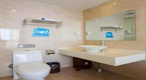 a bathroom with a white toilet and a sink at IU Hotel Changsha Yuanjialing Metro Station 2nd Hospital of Xiangya in Changsha +131 photos