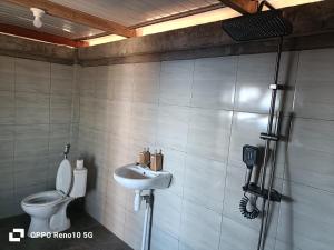 a bathroom with a toilet and a sink at The Indah Cliff Sea View in Polilit +48 photos