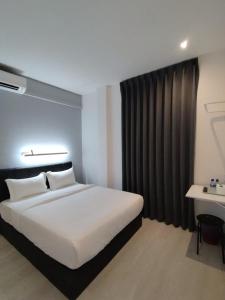 Rúm í herbergi á Self Check-In - Havona Hotel Plentong