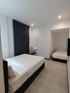 Rúm í herbergi á Self Check-In - Havona Hotel Plentong