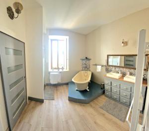 a bathroom with a tub and a sink and a toilet at Villa Denise in Vals-les-Bains