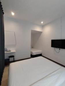 Rúm í herbergi á Self Check-In - Havona Hotel Plentong