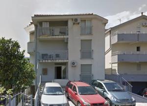 a group of cars parked in front of a building at Galeb in Igalo