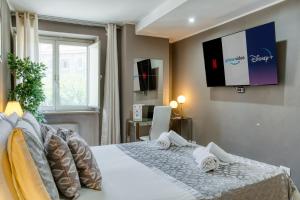 a bedroom with a bed with a television on the wall at Di Martino Residence in Rome