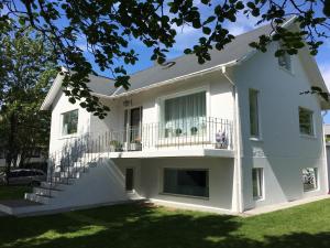 a white house with stairs and a balcony at Apartment 19 in Selfoss