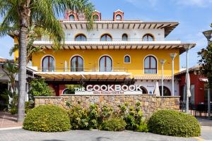 a building with a google book sign in front of it at The Cookbook Gastro Boutique Hotel & SPA in Calpe