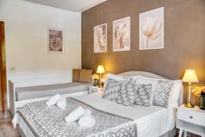 a hotel room with two beds and a couch at Di Martino Residence in Rome