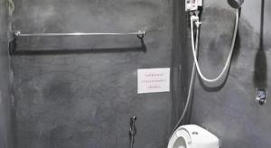 a bathroom with a toilet and a sign on the wall at Nawamit Home Garden in Nakhon Si Thammarat +45 photos