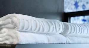 a pile of white towels sitting on a table at London Hotel in Macau