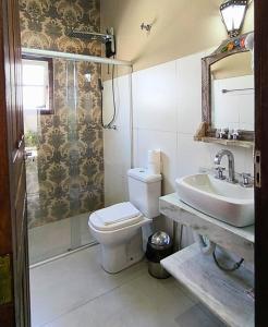 a bathroom with a toilet and a sink at Pousada Sinhá Vilaça in Tiradentes +46 photos