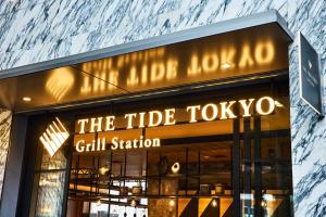 a building with a sign that reads the tribe tokyo girl station at Hotel Villa Fontaine Grand Tokyo-Shiodome in Tokyo