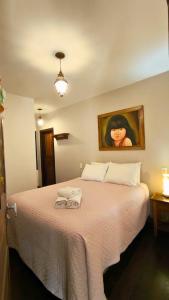 a bedroom with a bed with two towels on it at Pousada Sinhá Vilaça in Tiradentes