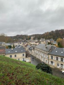 a view of a city from a hill with buildings at Hebergement insolite Boat Near Paris in Thourotte +15 photos