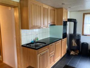 a kitchen with wooden cabinets and a sink at Uf em Schloss in Biel +19 photos