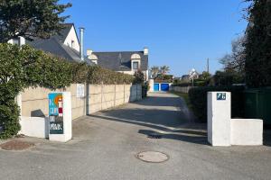 a house with a sign on the side of a street at Le Clos du Phare house 3 dans une copropriété privé in Quiberon