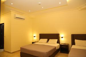 Ліжко або ліжка в номері Rumman Hotel