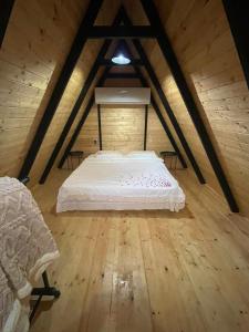 a room with a bed in a attic at Alisa's cottage in Racha ალისას კოტეჯი რაჭაში in Kharistʼvala