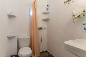 a bathroom with a toilet and a sink and a shower at Charmante ferienwohnung in Tinos Town +13 photos