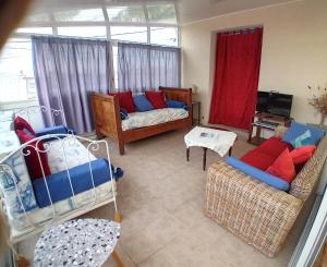 a living room with a couch and two chairs at Pluie de roses in Royan