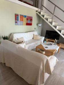 a living room with two beds and a staircase at Seaviewloft in Ofrínion