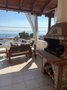 a patio with a fireplace and benches on a roof at Seaviewloft in Ofrínion